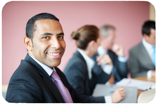 man in a meeting smiling 